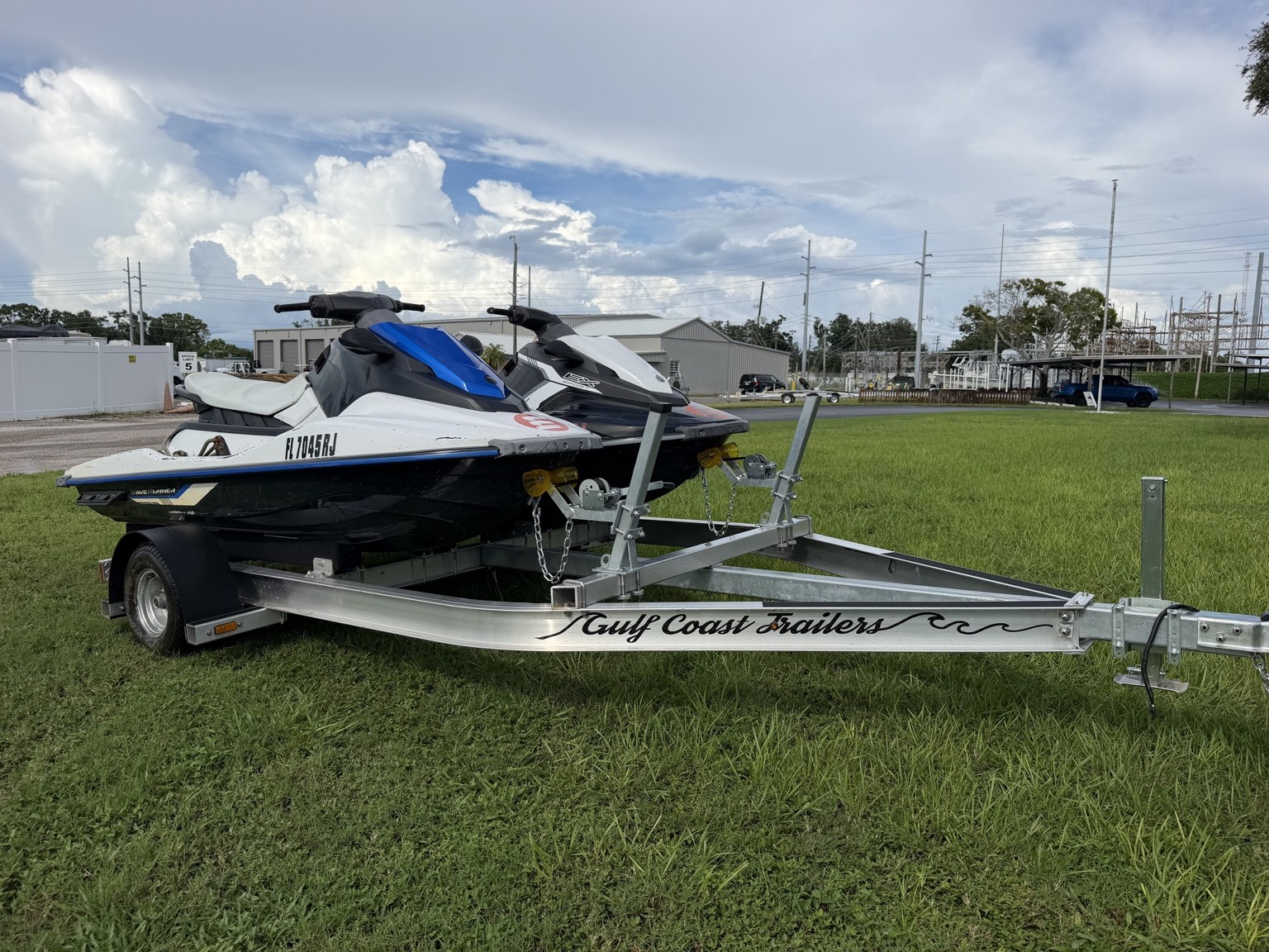 Commercial heavy-duty double jet ski trailer for lessons and rentals · loaded front three-quarter view