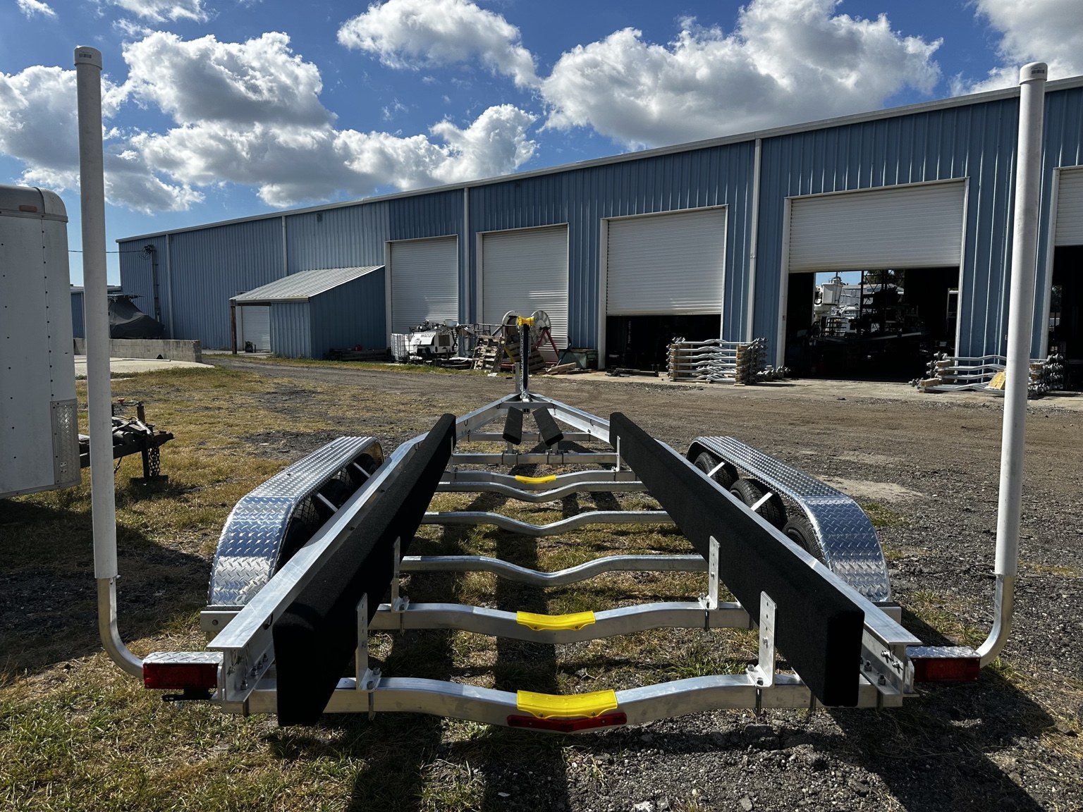 Rear view of hull-support bunks of a 10.5K triple-axle trailer