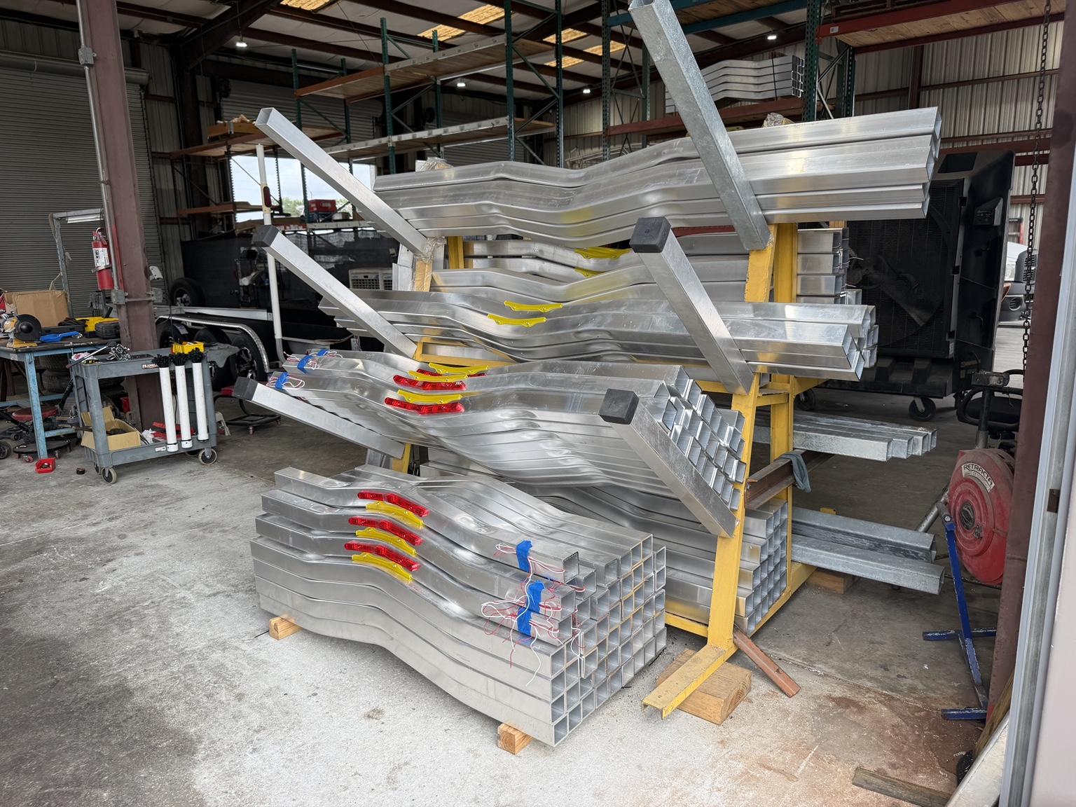 Aluminum trailer components ready for assembly.
