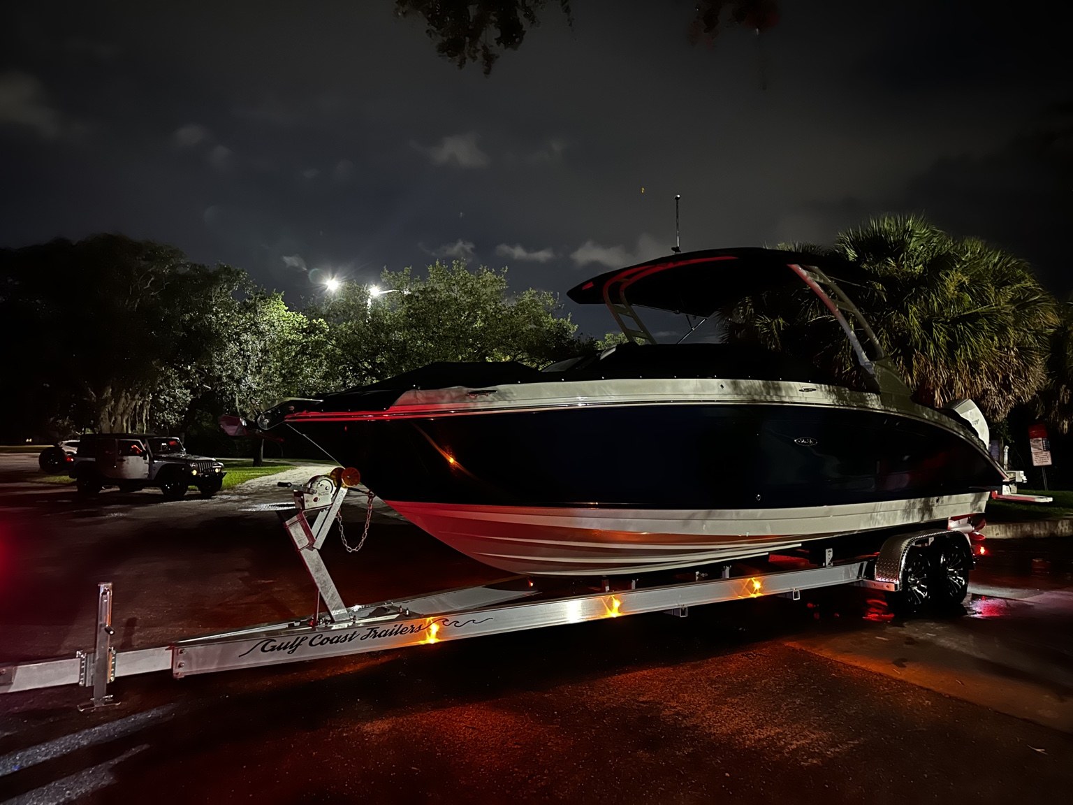 Sea Ray 290 SDX fitted to a Gulf Coast Trailers tandem-axle aluminum trailer at night
