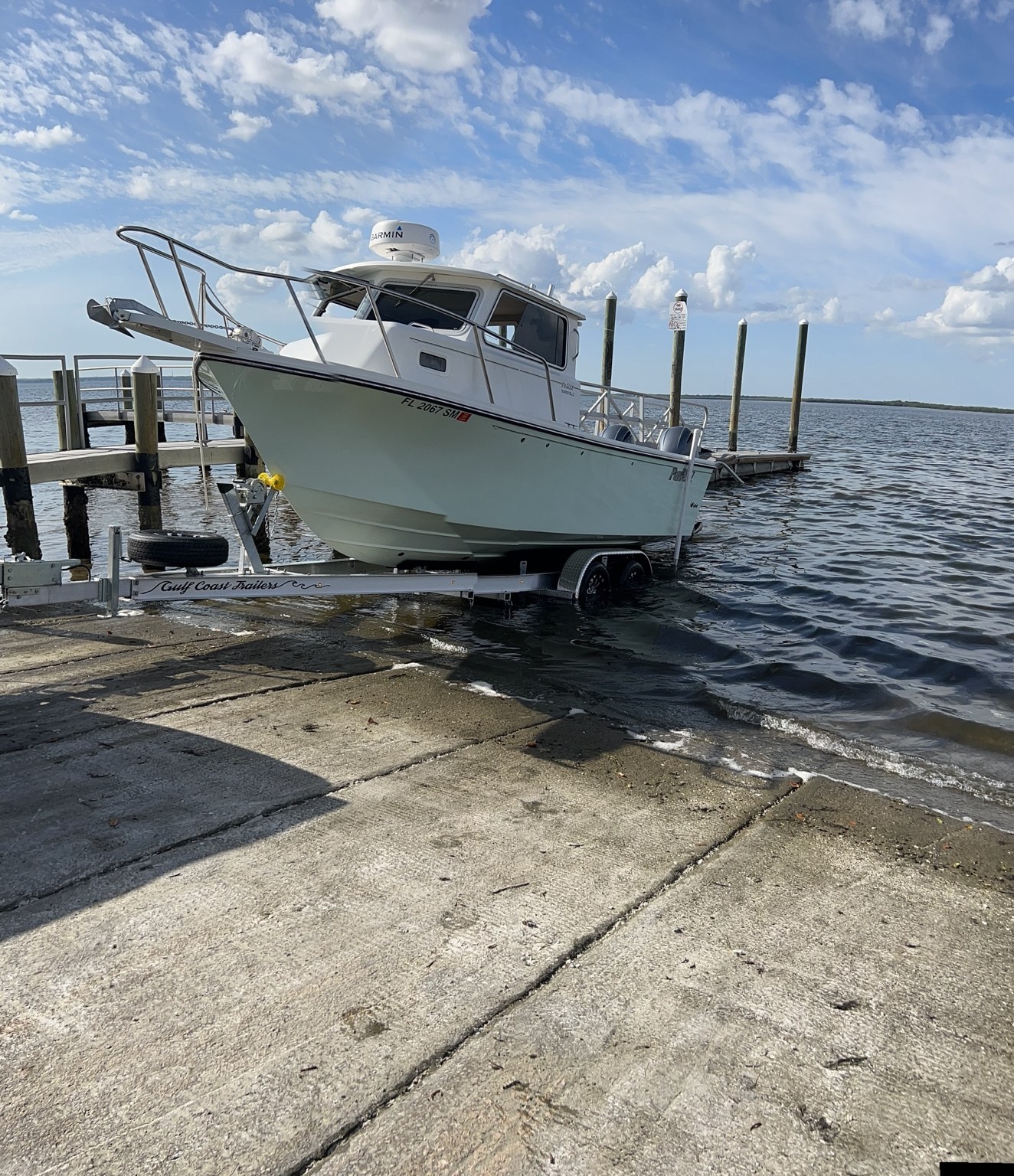 Parker pilothouse boat launching from a Gulf Coast Trailers tandem-axle aluminum trailer