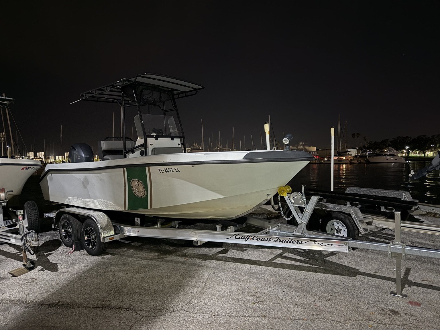 FWC enforcement vessel fitted to a branded Gulf Coast Trailers tandem-axle trailer at the marina